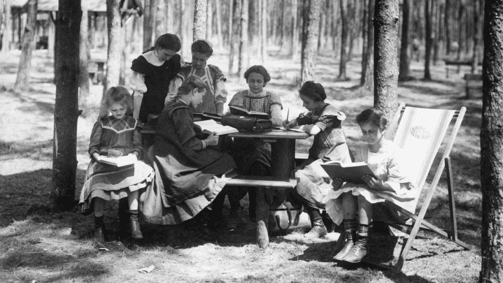 Open Air Schools - Black and white photo of students studying in the forest of Charlottenburg, Germany.