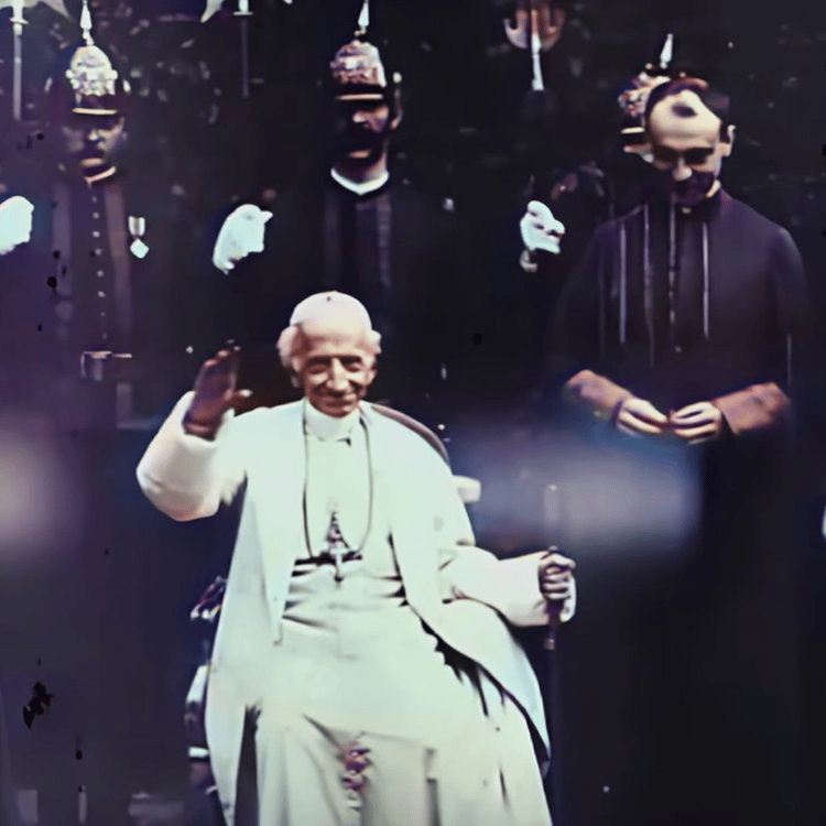 Still image from footage Pope Leo XIII , seated with right hand raised to camera for papal benediction.