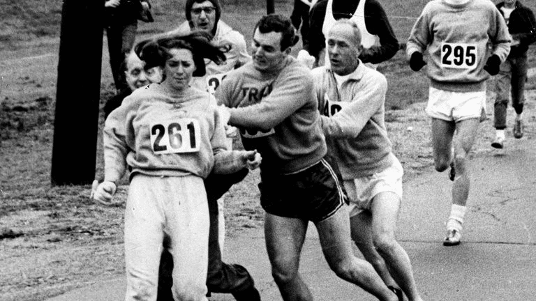 Switzer's boyfriend Tom Miller pushes marathon co-director Jock Semple away so Kathrine Switzer can continue running